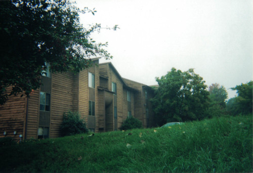 Before photo showing large side of condo looking quite worn.