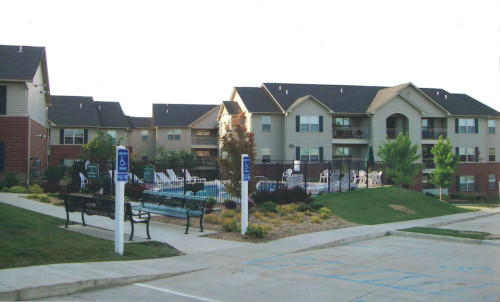 Before photo of the big apartment complex as seen from street.