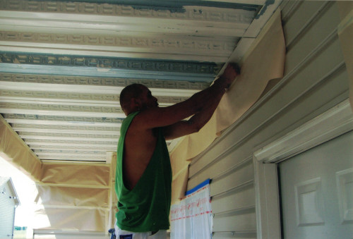Photo of masking the walls to safely work on ceiling.