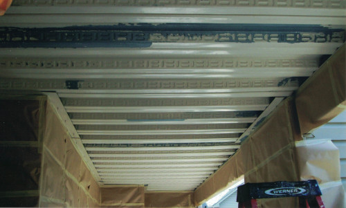 Photo of a hallway ceiling ready to be spray painted.