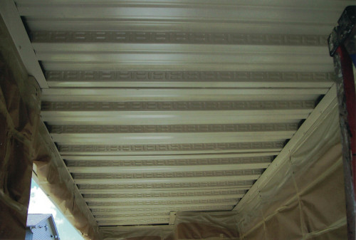 After photo of a finished metal ceiling w/ walls still masked.
