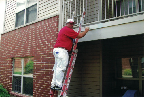 Photo of Scott priming the prepared metal surface by brush.