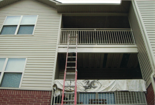 Photo of a ladder stretched far out to the 3rd story deck.