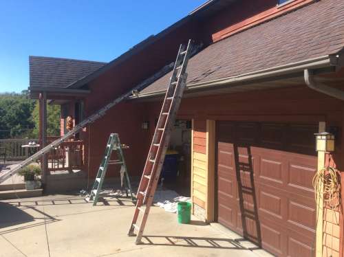 Photo of the garage port where new cedar siding had been put up that would need to match everything in the end.