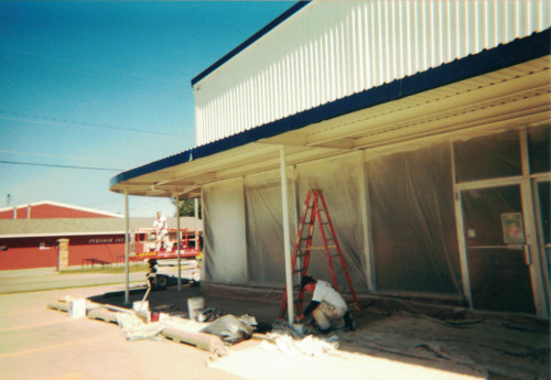 Photo of the small crew working on painting the overhang.