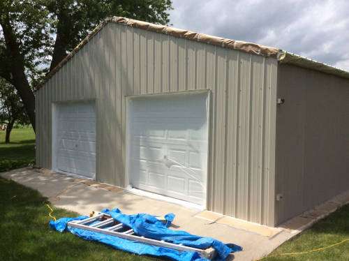 Photo of the garage port where new cedar siding had been put up that would need to match everything in the end.