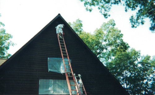 Photo of Scott masking off the front windows of the A-Frame.