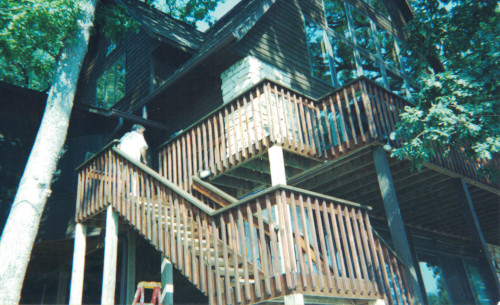 Photo of starting to restain the massive 3-story deck.